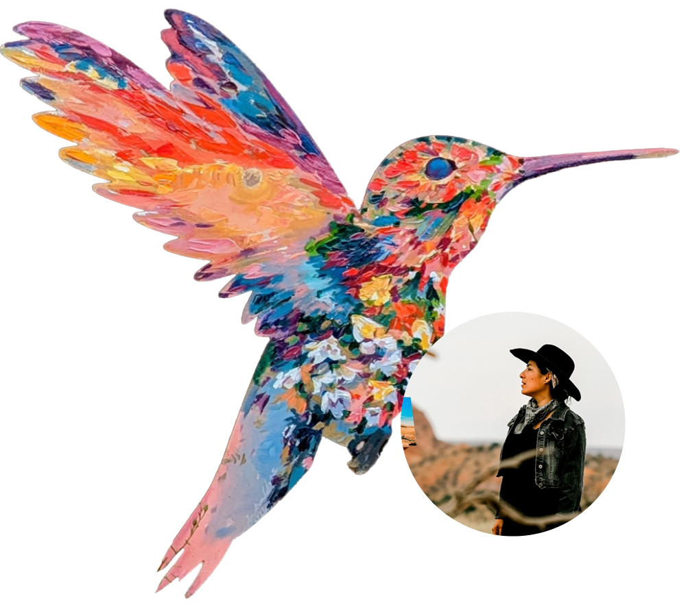 A colorful painted hummingbird sculpture at Ventura Botanical Gardens, outdoor nature scene.