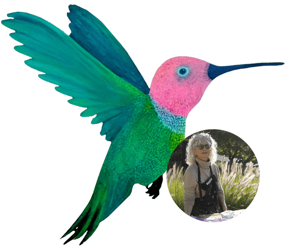 A colorful hummingbird sculpture at Ventura Botanical Gardens, with a person enjoying the garden sce.