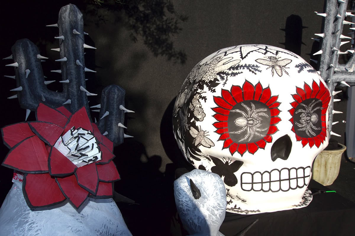 Decorative skull with floral patterns and cactus sculpture at Ventura Botanical Gardens.